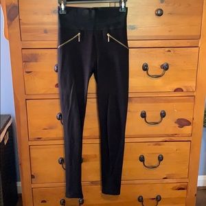 Black leggings with gold zipper details